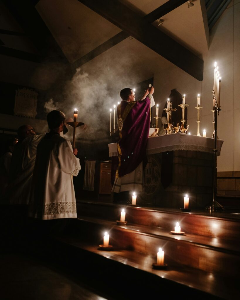 Priest holding up the Eucharist