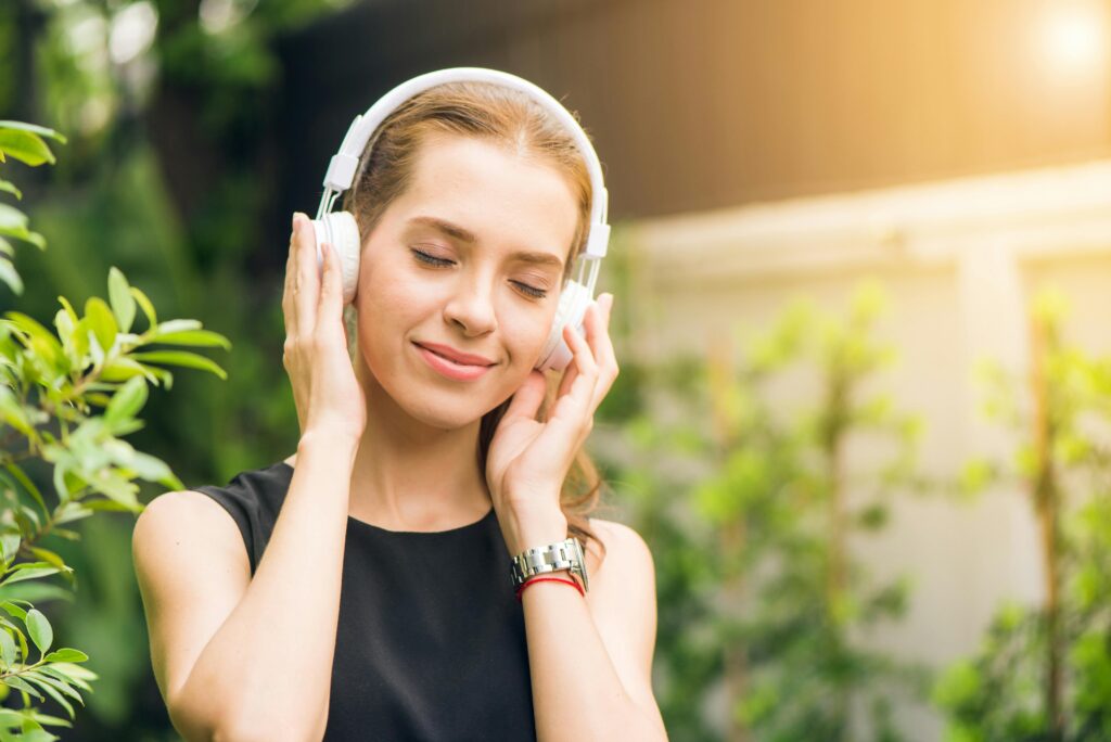 Woman with headphones listening to Catholic Radio