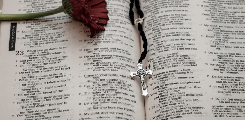 Open Bible with Rosary and flower, mass readings